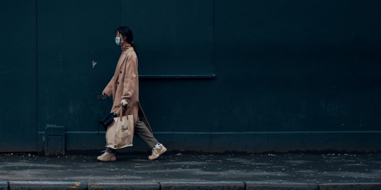 Coronavirus Pandemic Will Give Rise To A Disabled Generation 1 woman walking on footpath wearing mask