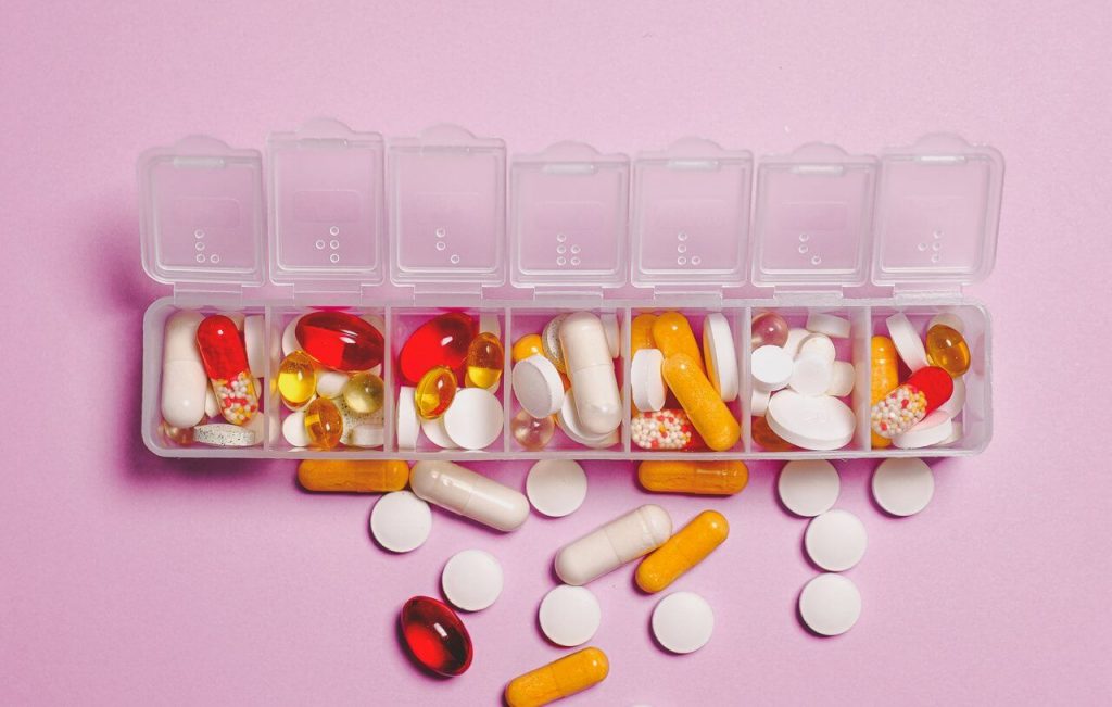 Image of plastic container including medicine and capsules