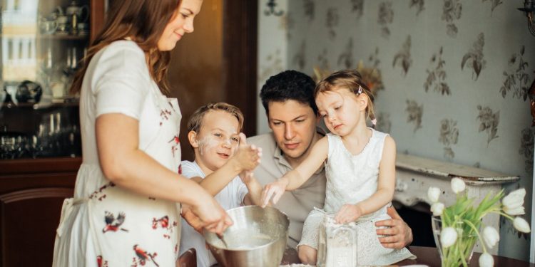 Family photo with children and parents mixing ingredients