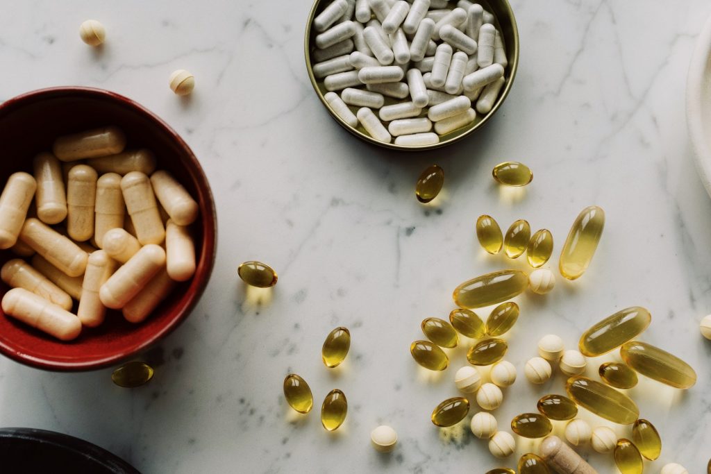 a table with vitamin D supplements on shelf and bowls