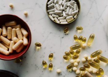 Vitamin D Does Not Prevent or Treat COVID-19: Experts Say 11 a table with vitamin D supplements on shelf and bowls