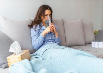 Woman having breathing difficulty and using oxygen mask