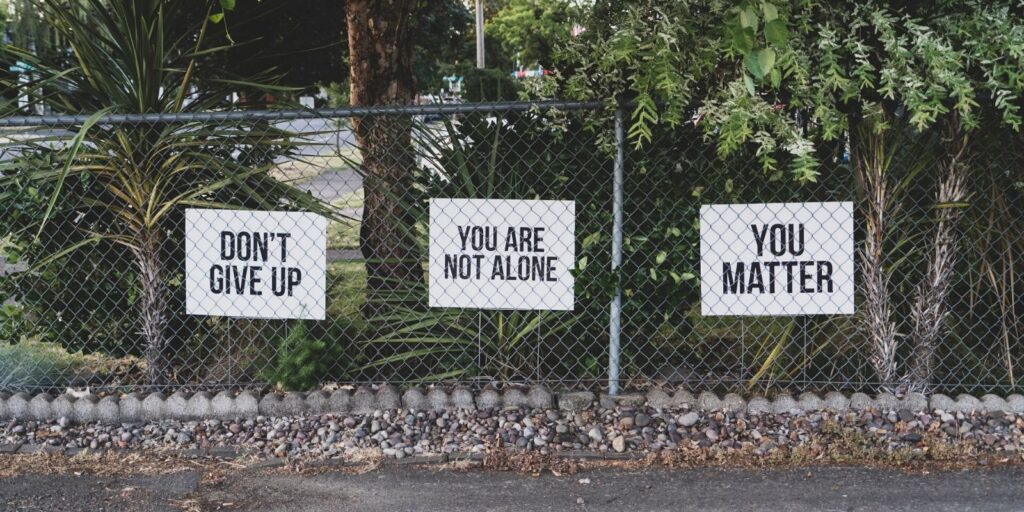 Fence with display cards saying You Matter and Don't Give Up