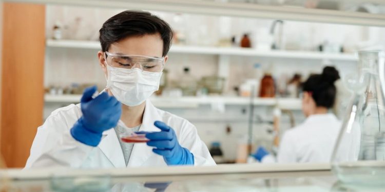 Breakthrough In Protein Treatment Trial For Coronavirus 1 Image of a Scientist conducting a sample test in Laboratory