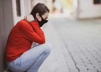Pandemic Potential: Swine Flu Spreading in China 11 Woman sitting on a footpath feeling distressed