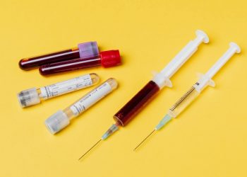 Australian Researchers Devised 20-Minute Coronavirus Blood Test 12 Syringes and blood test tube samples on a yellow background