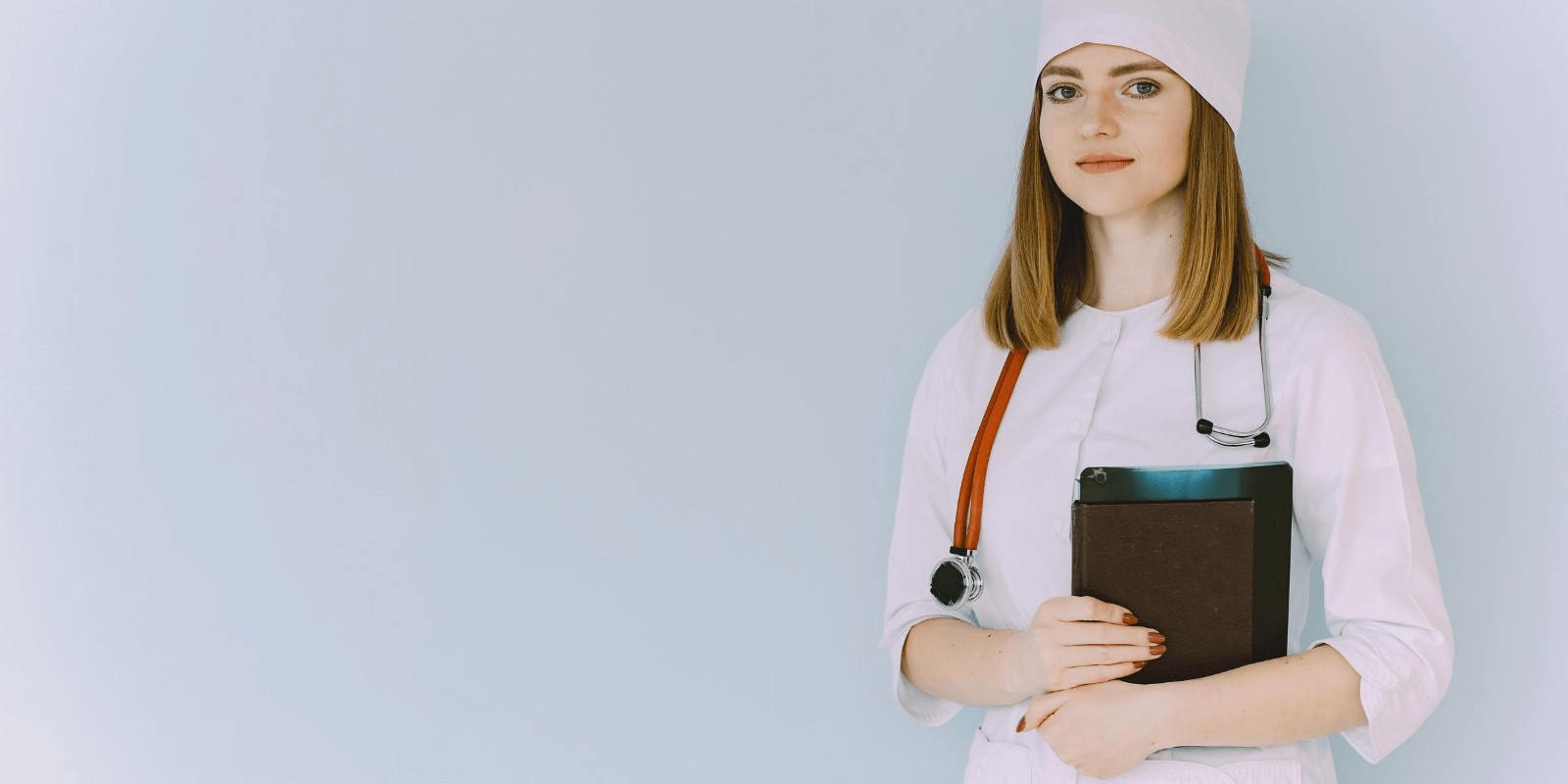 Image of Woman doctor wearing stethoscope and holding medical files