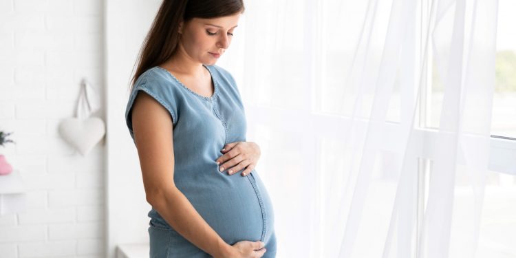 Marijuana Use In Pregnancy Might Cause Autism In Newborn, Study Says 1 Pregnant woman wearing blue frock standing in her room
