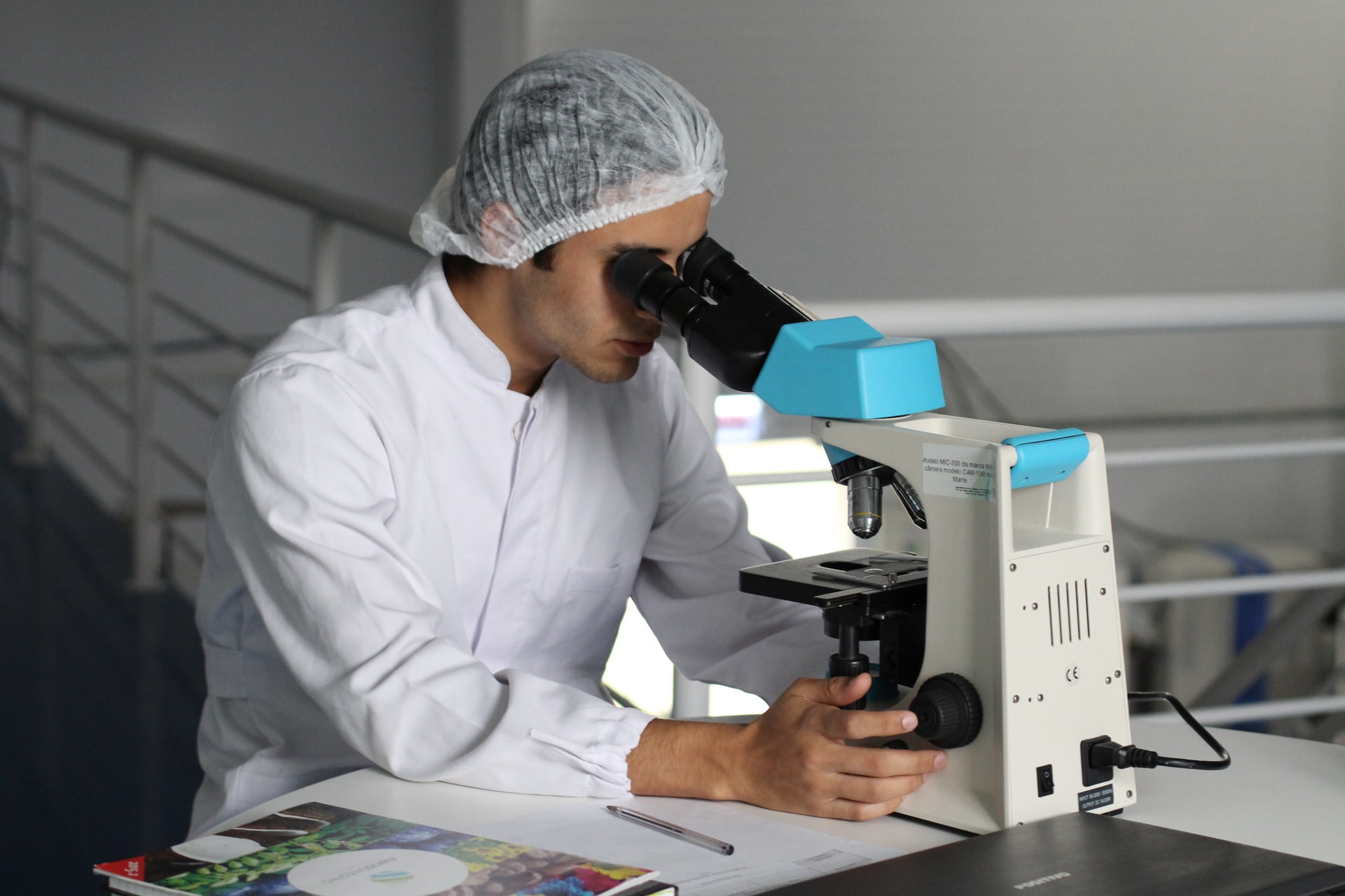 A researcher looks in an optical microscope