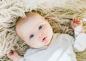Neural Brain Activity In Infants Predicts Autism Spectrum Disorder, Study Says 11 Image of an infant baby wearing white onesie and lying in the bed