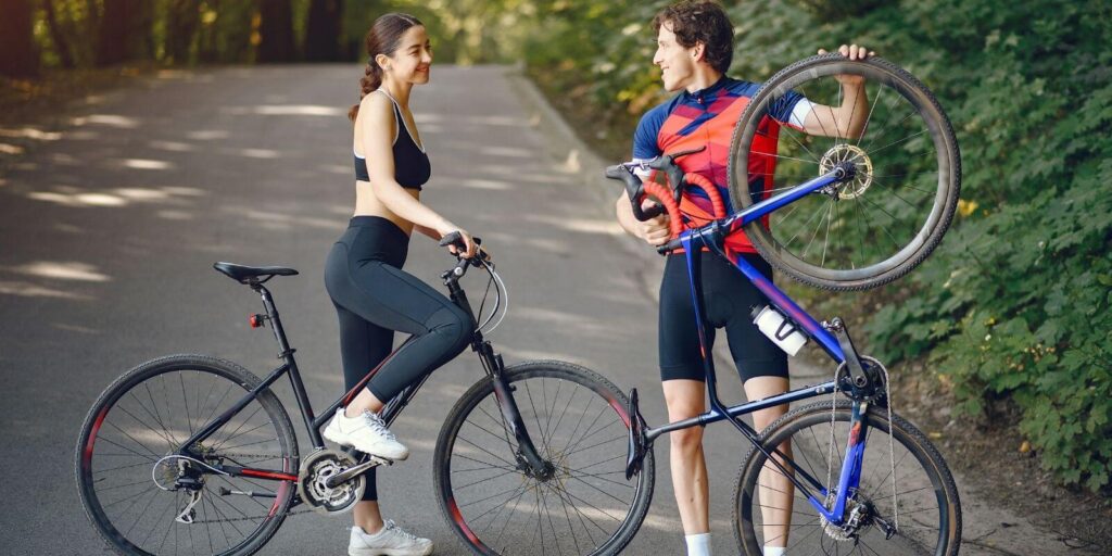 Photo of a young couple enjoying cycling and talking