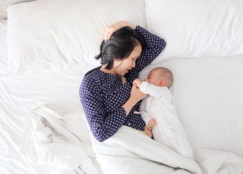 An asian woman breastfeeding a child