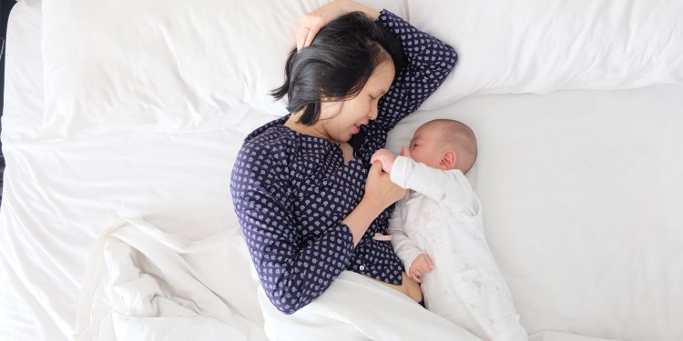 Must-Have Breastfeeding Accessories for New Moms 1 An asian woman breastfeeding a child