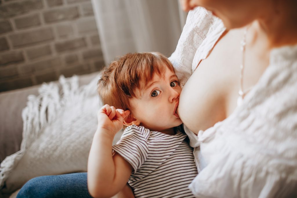 A white woman breastfeeding a child