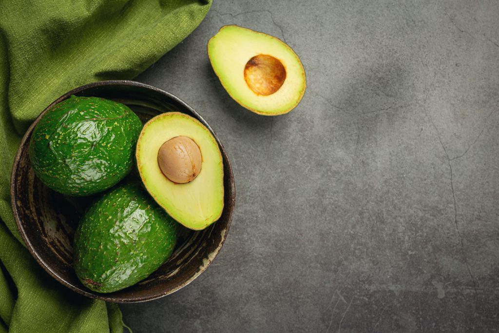 A photo showing green Avocado's in a jar