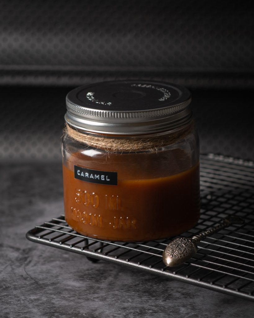 A jar filled with Caramel and labeled Caracel with black sticker