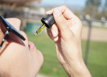 Does CBD Make You Hungry? 12 A woman consuming CBD oil