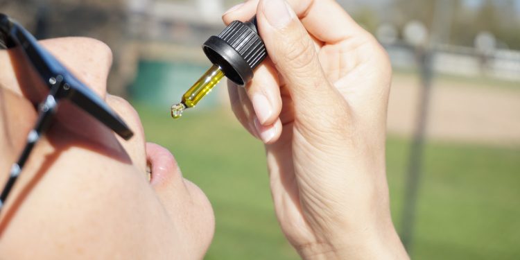 Does CBD Make You Hungry? 1 A woman consuming CBD oil