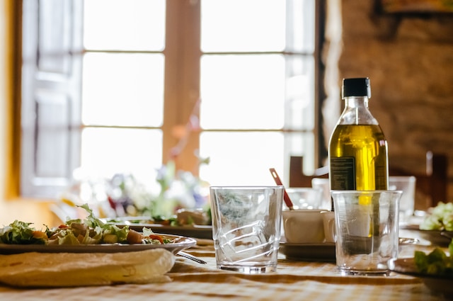 Olive oil bottle near food