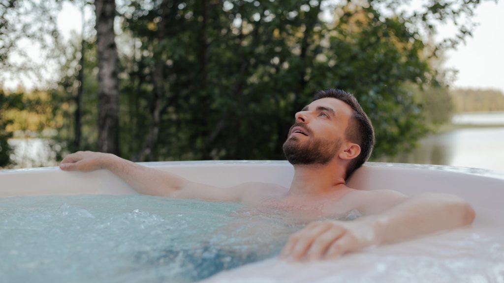 A person enjoying a hot tub bath in a sunny day